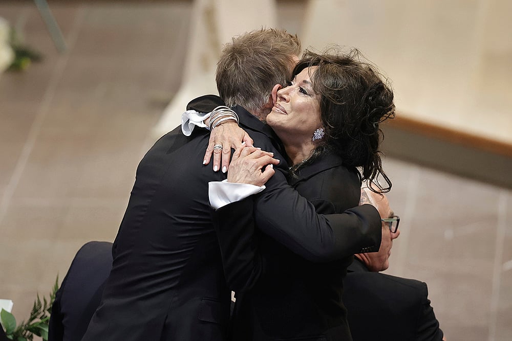 | Photo: Adam Ihse/TT News Agency via AP : Sven-Goran Eriksson Funeral: David Beckham and Nancy Dell'Olio hug as they arrive